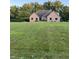 Lovely brick home featuring a sprawling green lawn and mature trees creating a serene and private setting at 5993 E County Road 100 S, Avon, IN 46123