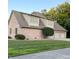 Spacious three-car garage featuring a brick exterior and well-maintained landscaping with mature trees at 5993 E County Road 100 S, Avon, IN 46123