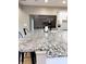 Kitchen featuring a granite countertop with black stools, white cabinets, and stainless steel appliances at 5993 E County Road 100 S, Avon, IN 46123