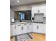 A kitchen features white cabinets, granite countertops, stainless steel appliances, and hardwood floors at 5993 E County Road 100 S, Avon, IN 46123