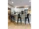 Kitchen featuring white cabinets, granite counters, stainless steel appliances, and black bar stools at a peninsula counter at 5993 E County Road 100 S, Avon, IN 46123