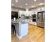 A kitchen features white cabinets, granite countertops, stainless steel appliances, and hardwood floors at 5993 E County Road 100 S, Avon, IN 46123
