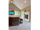 Comfortable living room featuring a cozy fireplace, large TV, and access to the backyard at 5993 E County Road 100 S, Avon, IN 46123