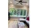 Bright living room featuring a ceiling fan, large windows offering a view of the backyard at 5993 E County Road 100 S, Avon, IN 46123