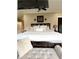Large bed with multiple pillows with a bench seat at the foot of the bed at 5993 E County Road 100 S, Avon, IN 46123