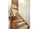 Carpeted staircase with a wooden banister and handrail leading to the upper level of the home at 5993 E County Road 100 S, Avon, IN 46123