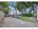Charming backyard with a wooden deck, surrounded by lush greenery and mature trees, perfect for outdoor entertaining at 6009 Ralston Ave, Indianapolis, IN 46220