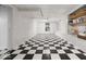 Basement with black and white checkerboard floors and built in storage, perfect for organization and recreation at 6009 Ralston Ave, Indianapolis, IN 46220