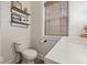 Bright bathroom featuring a wood vanity, hexagon tile floor, and shelving at 6009 Ralston Ave, Indianapolis, IN 46220