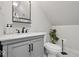 This bathroom features a modern vanity with a white countertop, sleek black hardware, and a stylish plant at 6009 Ralston Ave, Indianapolis, IN 46220