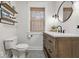 Bright bathroom featuring a wood vanity, hexagon tile floor, and shelving at 6009 Ralston Ave, Indianapolis, IN 46220