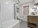Bright bathroom featuring subway tile, a modern vanity, hexagon tile floor, and natural light at 6009 Ralston Ave, Indianapolis, IN 46220
