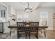 Elegant dining room with a wooden table, upholstered chairs, and modern lighting at 6009 Ralston Ave, Indianapolis, IN 46220