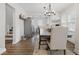 Cozy dining area with wood floors, a rustic chandelier and a staircase to the left at 6009 Ralston Ave, Indianapolis, IN 46220