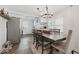 Dining area with a wooden table, neutral chairs, and modern lighting open to kitchen at 6009 Ralston Ave, Indianapolis, IN 46220