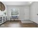 Bright entryway with wood floors, a white bench, and a decorative cabinet at 6009 Ralston Ave, Indianapolis, IN 46220