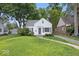 Classic single-Gathering home with manicured lawn, detached garage, and mature trees at 6009 Ralston Ave, Indianapolis, IN 46220