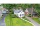 Charming single-Gathering home boasts a well-manicured lawn, mature trees, and inviting curb appeal at 6009 Ralston Ave, Indianapolis, IN 46220