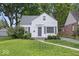 Charming single-Gathering home with a well-manicured lawn and a classic white facade at 6009 Ralston Ave, Indianapolis, IN 46220