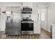 Kitchen boasts stainless steel appliances, white cabinets, and stylish tile backsplash at 6009 Ralston Ave, Indianapolis, IN 46220