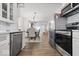 A kitchen featuring stainless steel appliances, white cabinets, and an open concept dining area at 6009 Ralston Ave, Indianapolis, IN 46220