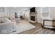 Bright, open living room with a stone fireplace, wood floors, and a comfortable seating area at 6009 Ralston Ave, Indianapolis, IN 46220