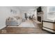 Open-concept living room with a stone fireplace, wood floors, and modern decor at 6009 Ralston Ave, Indianapolis, IN 46220