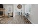 Cozy living room with a stone fireplace, wood floors, and ample natural light at 6009 Ralston Ave, Indianapolis, IN 46220