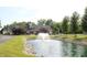 Royal Run Village Club's clubhouse features a beautiful fountain, mature trees, and playground at 6298 Briargate Dr, Zionsville, IN 46077