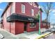 Exterior view of The Friendly Tavern featuring a black awning and inviting entrance at 6298 Briargate Dr, Zionsville, IN 46077