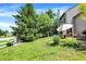 Exterior view showcasing the backyard, patio with seating, and lush landscaping on a sunny day at 6298 Briargate Dr, Zionsville, IN 46077