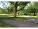 Lush green grounds featuring a path and mature trees offer a tranquil park-like setting at 6298 Briargate Dr, Zionsville, IN 46077