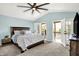 Spacious main bedroom featuring light blue walls, ceiling fan, access to a private balcony, and a large bed at 6298 Briargate Dr, Zionsville, IN 46077