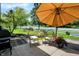 Cozy patio seating area with an umbrella and a view of the landscaped yard at 6298 Briargate Dr, Zionsville, IN 46077