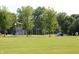 Community playground with swings, slides, and climbing structures surrounded by lush green space at 6298 Briargate Dr, Zionsville, IN 46077