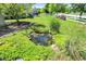 Charming backyard pond surrounded by vibrant greenery, adding a touch of nature to the property at 6298 Briargate Dr, Zionsville, IN 46077