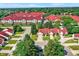 Stunning aerial view of a vibrant community featuring red roofs, lush greenery, and well-maintained streets at 6402 Friendship Cir, Indianapolis, IN 46268