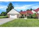 Welcoming townhome with an attached garage, pleasant front yard, and charming curb appeal at 6402 Friendship Cir, Indianapolis, IN 46268