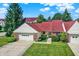 Charming townhome boasts a red roof, attached garage and inviting curb appeal at 6402 Friendship Cir, Indianapolis, IN 46268