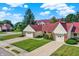 Well-maintained townhomes featuring attached garages, manicured lawns and red roofs at 6402 Friendship Cir, Indianapolis, IN 46268