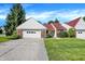 Exterior view of a single-story home with an attached garage and a neatly maintained front lawn at 6402 Friendship Cir, Indianapolis, IN 46268