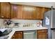 The kitchen features wood cabinets, stainless steel appliances, and white countertops at 6402 Friendship Cir, Indianapolis, IN 46268
