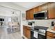 The kitchen features wood cabinets, stainless steel appliances and an adjacent dining area at 6402 Friendship Cir, Indianapolis, IN 46268