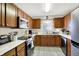 Well-equipped kitchen featuring wood cabinets, stainless steel appliances, and laminate countertops at 6402 Friendship Cir, Indianapolis, IN 46268