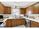 Well-equipped kitchen featuring wood cabinets, stainless steel appliances, and laminate countertops at 6402 Friendship Cir, Indianapolis, IN 46268