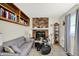 Cozy living room featuring a brick fireplace, a grey sofa, and a drum set at 6402 Friendship Cir, Indianapolis, IN 46268