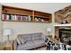 Comfortable living room with built-in shelves, a brick fireplace, and a grey sofa at 6402 Friendship Cir, Indianapolis, IN 46268