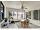 Enclosed sunroom area with white-painted beadboard, lots of natural light, and an exercise bike at 6402 Friendship Cir, Indianapolis, IN 46268