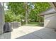 Spacious backyard featuring a patio area with grills, lush green space, and mature trees at 6430 N Rural St, Indianapolis, IN 46220