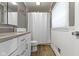 Bathroom featuring white vanity with stone countertop and shower/tub combo at 6430 N Rural St, Indianapolis, IN 46220